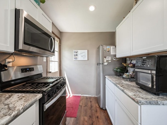 1 E Jefferson Ave S, Urbana, IA 52345 - kitchen featuring stainless steel appliances, dark wood finished floors, white cabinetry, recessed lighting, and light stone countertops