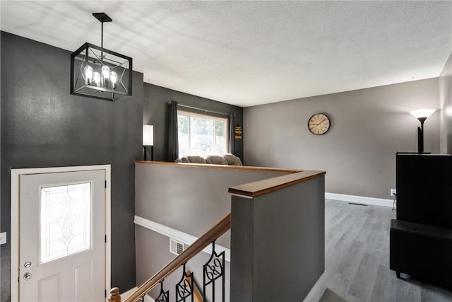 3140 Stratford Ln SW, Cedar Rapids, IA 52404 - foyer featuring wood finished floors and a chandelier