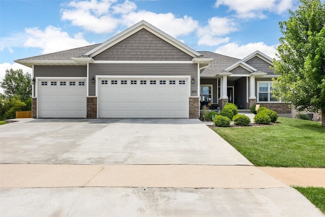 605 Alexis Ln, Marion, IA 52302 - craftsman house with stone siding, a garage, and driveway