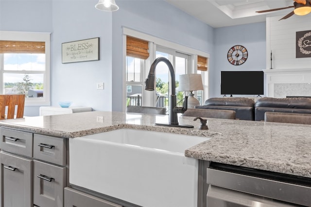 605 Alexis Ln, Marion, IA 52302 - kitchen with a ceiling fan, light stone counters, open floor plan, gray cabinets, and dishwashing machine