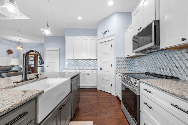 605 Alexis Ln, Marion, IA 52302 - kitchen with stainless steel appliances, decorative light fixtures, backsplash, dark wood-style flooring, and white cabinets