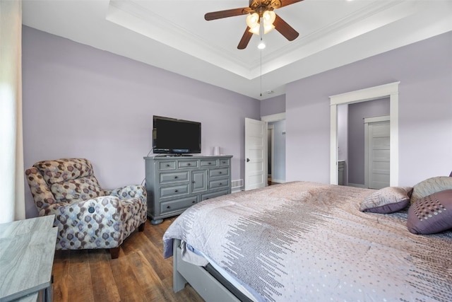 605 Alexis Ln, Marion, IA 52302 - bedroom with dark wood-style flooring, a raised ceiling, crown molding, and a ceiling fan