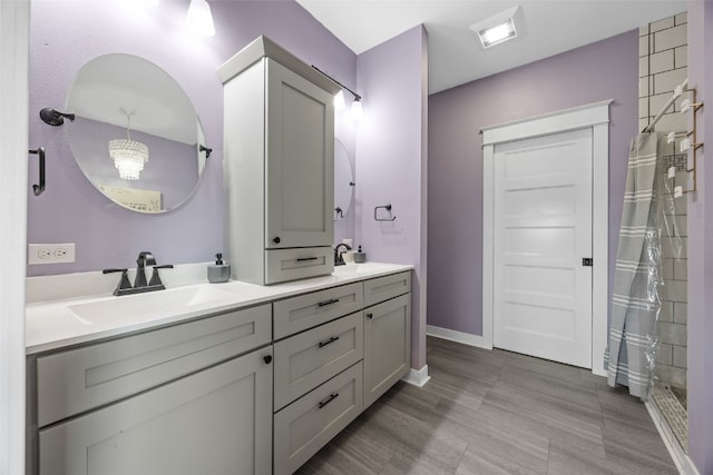 605 Alexis Ln, Marion, IA 52302 - bathroom with double vanity, a tile shower, and a chandelier