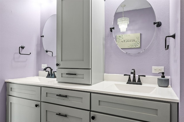 605 Alexis Ln, Marion, IA 52302 - bathroom featuring double vanity and a chandelier