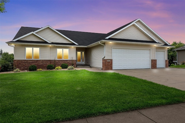 6845 Flint Rock Ct, Marion, IA 52302 - view of front facade featuring an attached garage, brick siding, driveway, a yard, and french doors
