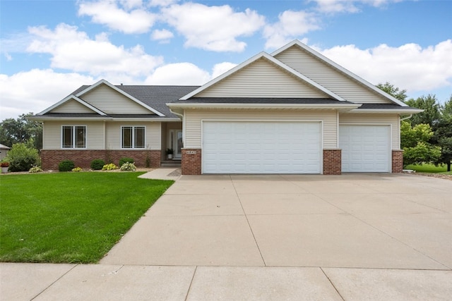 6845 Flint Rock Ct, Marion, IA 52302 - view of front of home featuring brick siding, a garage, a front yard, and concrete driveway