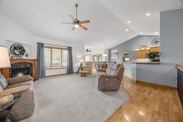 6845 Flint Rock Ct, Marion, IA 52302 - living room with a ceiling fan, vaulted ceiling, a high end fireplace, light wood finished floors, and recessed lighting