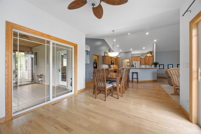 6845 Flint Rock Ct, Marion, IA 52302 - dining area featuring lofted ceiling, light wood finished floors, a ceiling fan, and recessed lighting