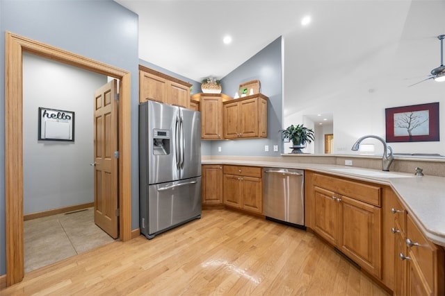 6845 Flint Rock Ct, Marion, IA 52302 - kitchen featuring stainless steel appliances, light countertops, light wood finished floors, a ceiling fan, and brown cabinets