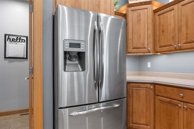 6845 Flint Rock Ct, Marion, IA 52302 - kitchen featuring stainless steel refrigerator with ice dispenser, light countertops, and brown cabinetry