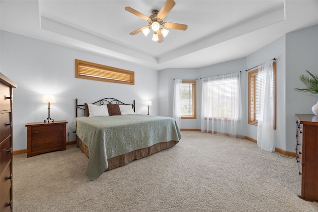 6845 Flint Rock Ct, Marion, IA 52302 - carpeted bedroom featuring a tray ceiling and ceiling fan