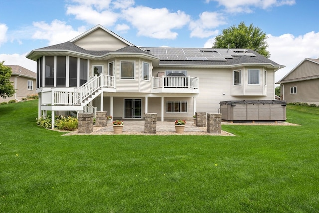 6845 Flint Rock Ct, Marion, IA 52302 - rear view of property with a patio, a sunroom, a hot tub, and a lawn