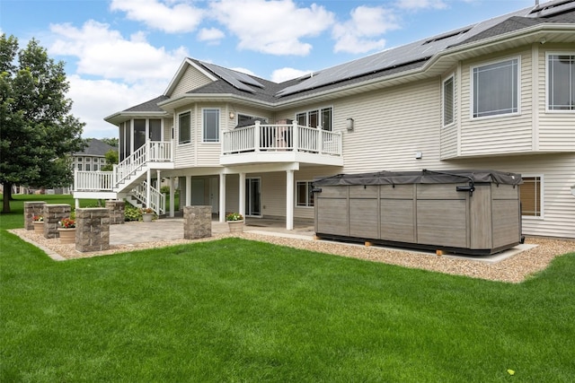 6845 Flint Rock Ct, Marion, IA 52302 - back of house with a patio area, roof mounted solar panels, a sunroom, a wooden deck, and a lawn