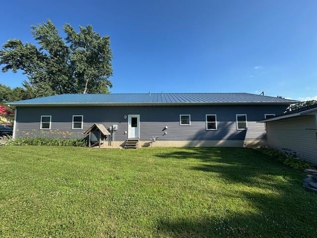 832 E Main St, Central City, IA 52214 - rear view of house featuring entry steps, a yard, and a metal roof
