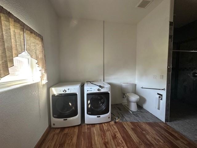 832 E Main St, Central City, IA 52214 - laundry area featuring separate washer and dryer and wood finished floors