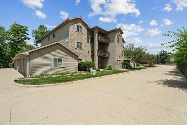 3028 Center Point Rd NE Unit 201, Cedar Rapids, IA 52402 - view of property exterior with concrete driveway and a garage