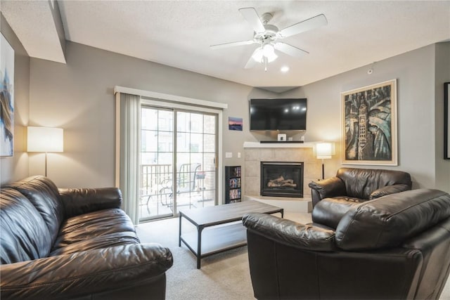 3028 Center Point Rd NE Unit 201, Cedar Rapids, IA 52402 - carpeted living room featuring a tiled fireplace and a ceiling fan
