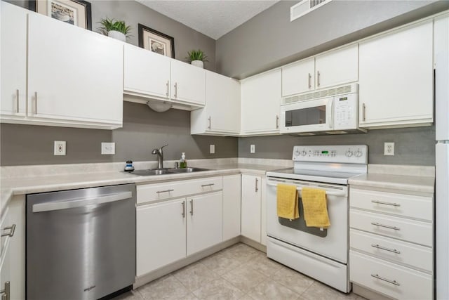 3028 Center Point Rd NE Unit 201, Cedar Rapids, IA 52402 - kitchen with white appliances, light countertops, white cabinets, and a textured ceiling
