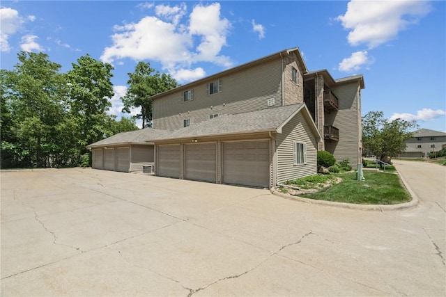 3028 Center Point Rd NE Unit 201, Cedar Rapids, IA 52402 - view of property exterior with driveway, an attached garage, and cooling unit