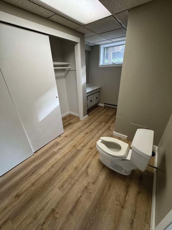 1852 215th St, Manchester, IA 52057 - bathroom with wood finished floors and baseboard heating