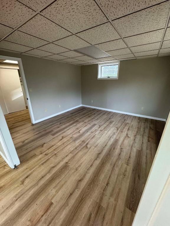 1852 215th St, Manchester, IA 52057 - empty room with wood finished floors and a paneled ceiling