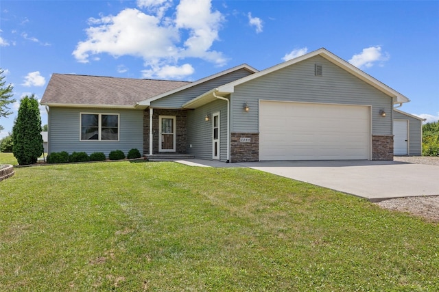 2089 117th Ct, Kalona, IA 52247 - view of front facade with an attached garage, driveway, a front yard, and stone siding