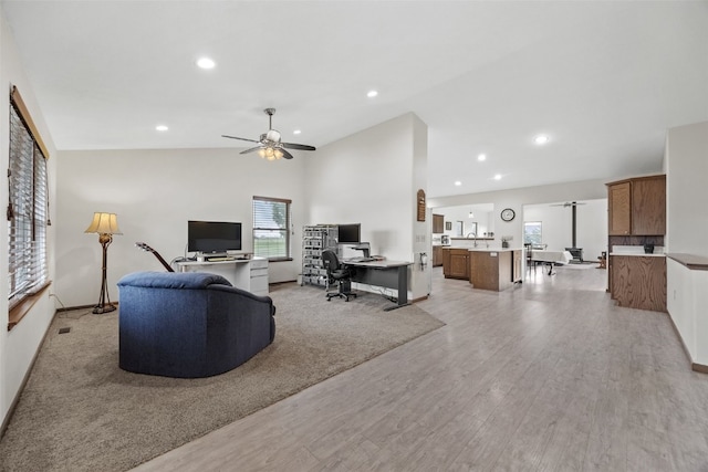 2089 117th Ct, Kalona, IA 52247 - living room with an office area, vaulted ceiling, light wood-style floors, a ceiling fan, and recessed lighting