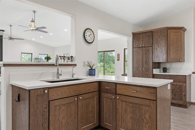 2089 117th Ct, Kalona, IA 52247 - kitchen featuring a peninsula, lofted ceiling, ceiling fan, plenty of natural light, and light countertops