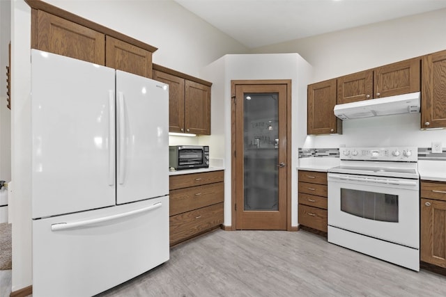 2089 117th Ct, Kalona, IA 52247 - kitchen with white appliances, extractor fan, light wood-style flooring, light countertops, and brown cabinetry