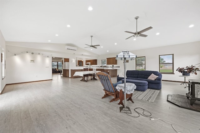 2089 117th Ct, Kalona, IA 52247 - living area with an AC wall unit, lofted ceiling, light wood-style flooring, a ceiling fan, and recessed lighting