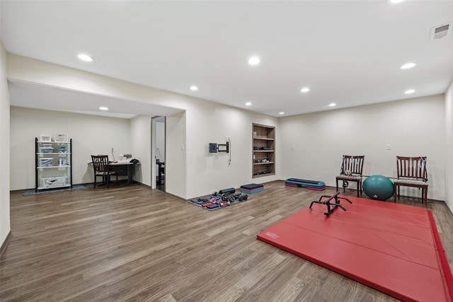 2089 117th Ct, Kalona, IA 52247 - exercise area featuring wood finished floors, recessed lighting, and built in features
