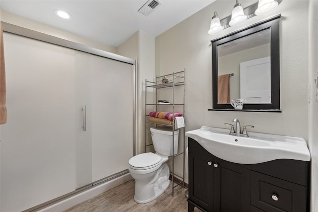 2089 117th Ct, Kalona, IA 52247 - bathroom featuring wood finished floors, vanity, and a shower stall