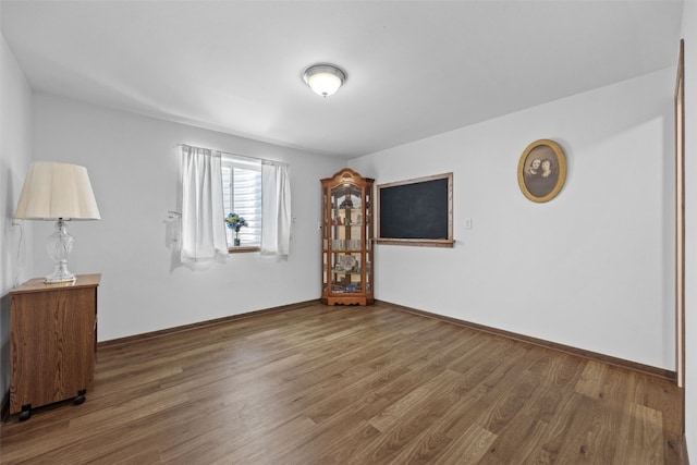 2089 117th Ct, Kalona, IA 52247 - spare room with wood finished floors and baseboards