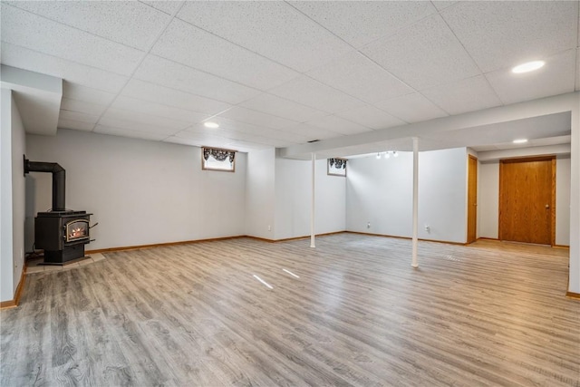 5524 Cimarron Ct, Marion, IA 52302 - below grade area featuring light wood-style floors, a paneled ceiling, a wood stove, and recessed lighting