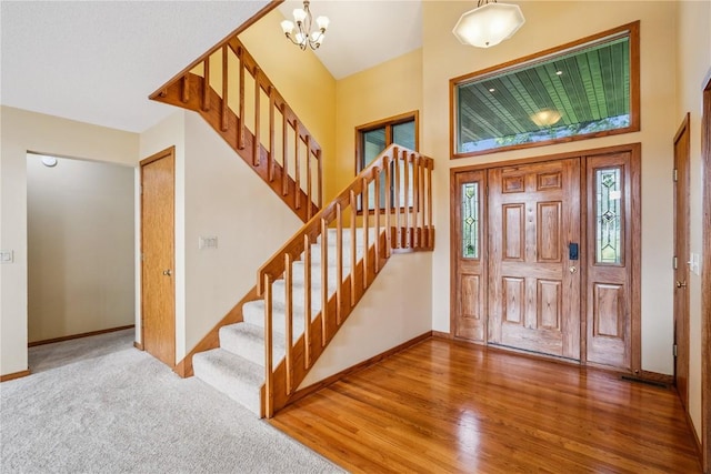 5524 Cimarron Ct, Marion, IA 52302 - foyer entrance featuring stairway, a chandelier, wood finished floors, and a high ceiling