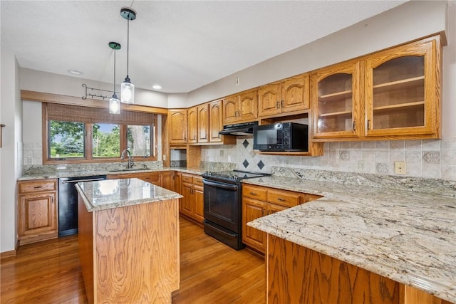 5524 Cimarron Ct, Marion, IA 52302 - kitchen featuring black appliances, light stone countertops, light wood-style flooring, brown cabinetry, and recessed lighting
