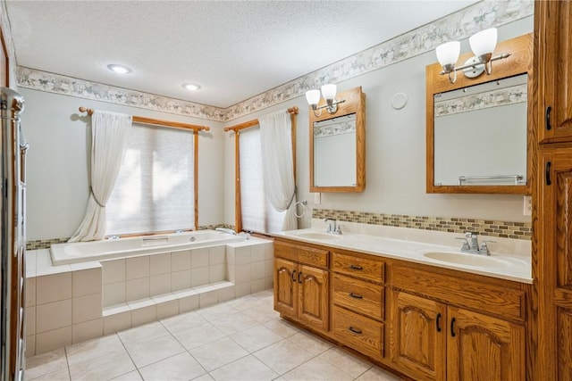 5524 Cimarron Ct, Marion, IA 52302 - bathroom with double vanity, tiled tub, a textured ceiling, and tile patterned flooring