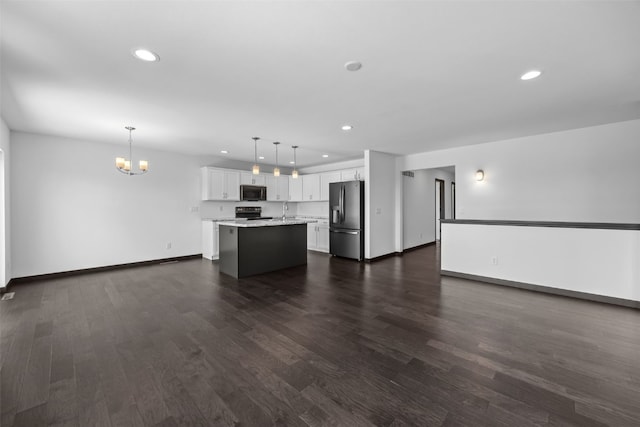 1921 Bowstring Dr, Marion, IA 52302 - unfurnished living room featuring a chandelier, recessed lighting, and dark wood-type flooring