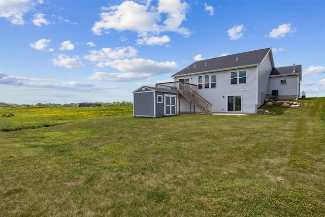 1921 Bowstring Dr, Marion, IA 52302 - rear view of house featuring stairs, a storage unit, a lawn, a deck, and a patio area