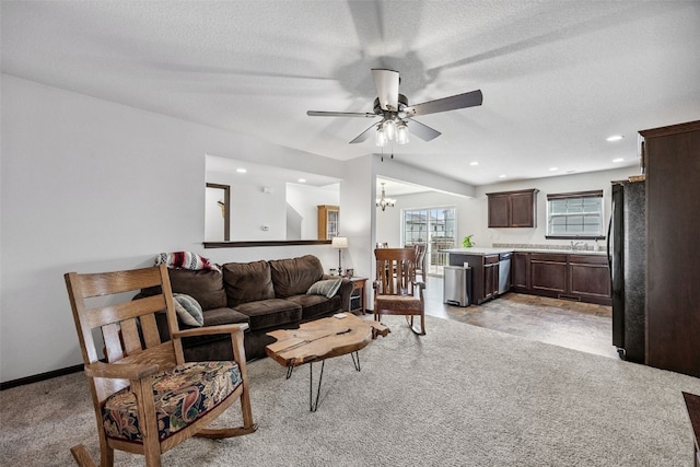 121 Woodstone Ln SW, Cedar Rapids, IA 52404 - living room with ceiling fan, a chandelier, a textured ceiling, and recessed lighting