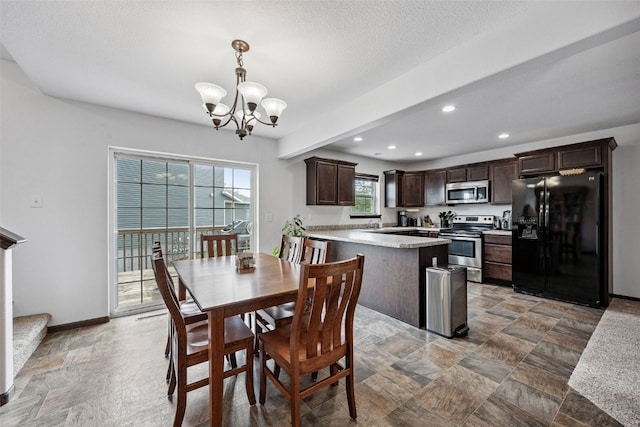 121 Woodstone Ln SW, Cedar Rapids, IA 52404 - dining area with a chandelier, recessed lighting, and light stone finish floors