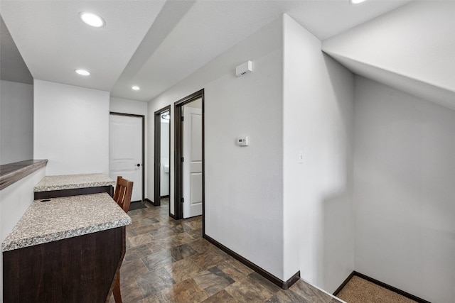 121 Woodstone Ln SW, Cedar Rapids, IA 52404 - corridor featuring recessed lighting and stone finish floors