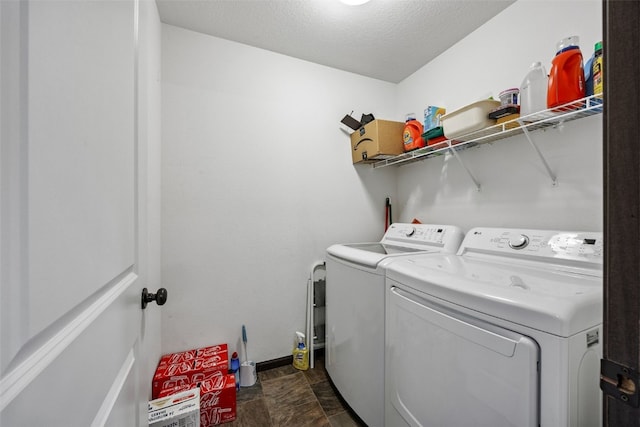 121 Woodstone Ln SW, Cedar Rapids, IA 52404 - laundry area with washing machine and dryer, stone finish floors, and a textured ceiling