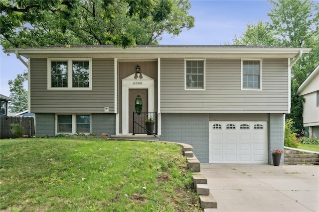 6808 Kelburn Ln NE, Cedar Rapids, IA 52402 - bi-level home with brick siding, an attached garage, and concrete driveway