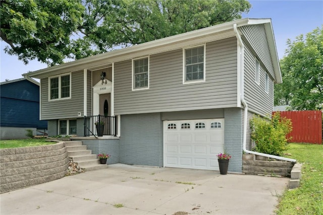 6808 Kelburn Ln NE, Cedar Rapids, IA 52402 - raised ranch with an attached garage, brick siding, and concrete driveway
