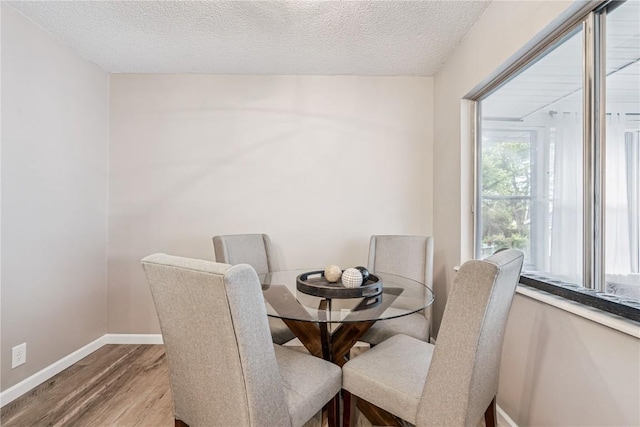 6808 Kelburn Ln NE, Cedar Rapids, IA 52402 - dining room with wood finished floors and a textured ceiling
