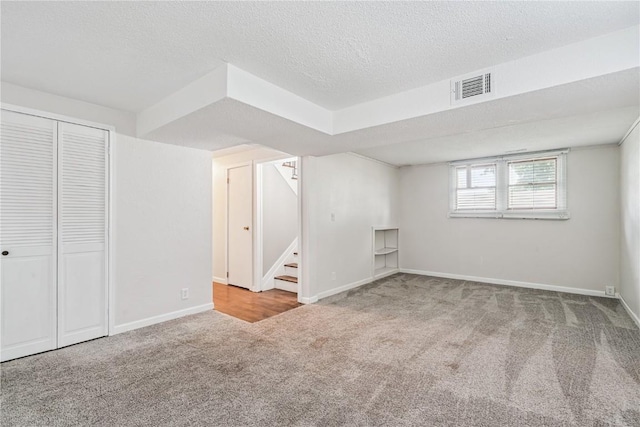 6808 Kelburn Ln NE, Cedar Rapids, IA 52402 - below grade area with carpet flooring, stairs, and a textured ceiling