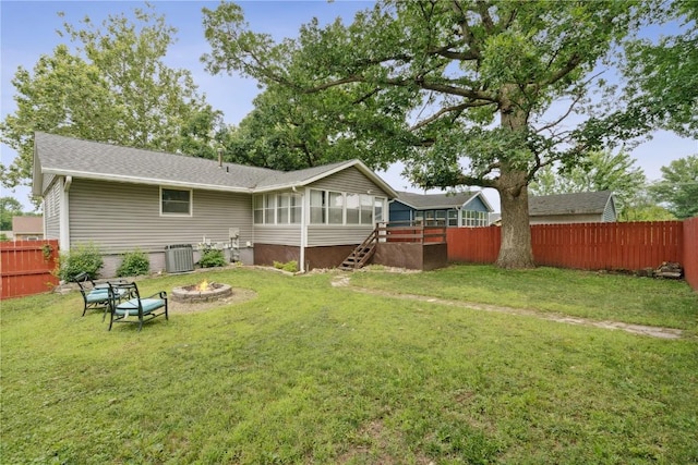 6808 Kelburn Ln NE, Cedar Rapids, IA 52402 - back of property featuring a sunroom, a fire pit, a fenced backyard, and stairway