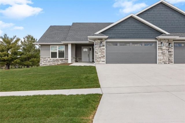 468 Chamber Dr, Anamosa, IA 52205 - craftsman-style home featuring an attached garage, stone siding, concrete driveway, a front lawn, and roof with shingles