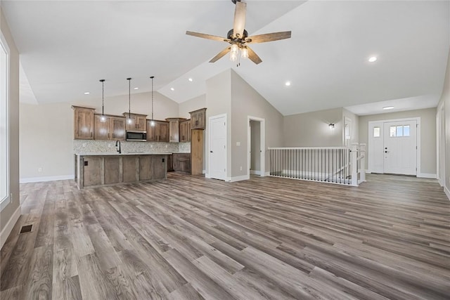 468 Chamber Dr, Anamosa, IA 52205 - unfurnished living room with wood finished floors, a ceiling fan, recessed lighting, and high vaulted ceiling